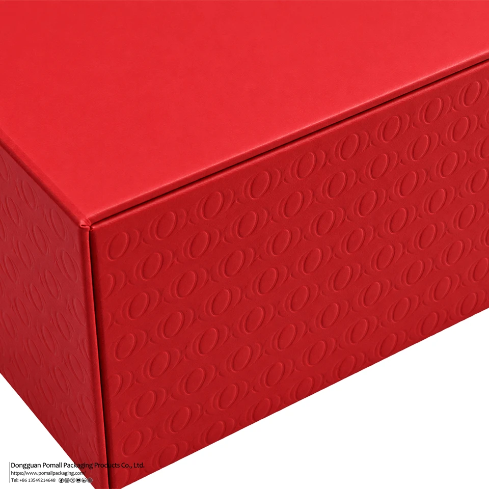 Close-up of embossed logo detail on red foldable apparel gift box Close-up of embossed logo detail on red foldable apparel gift box